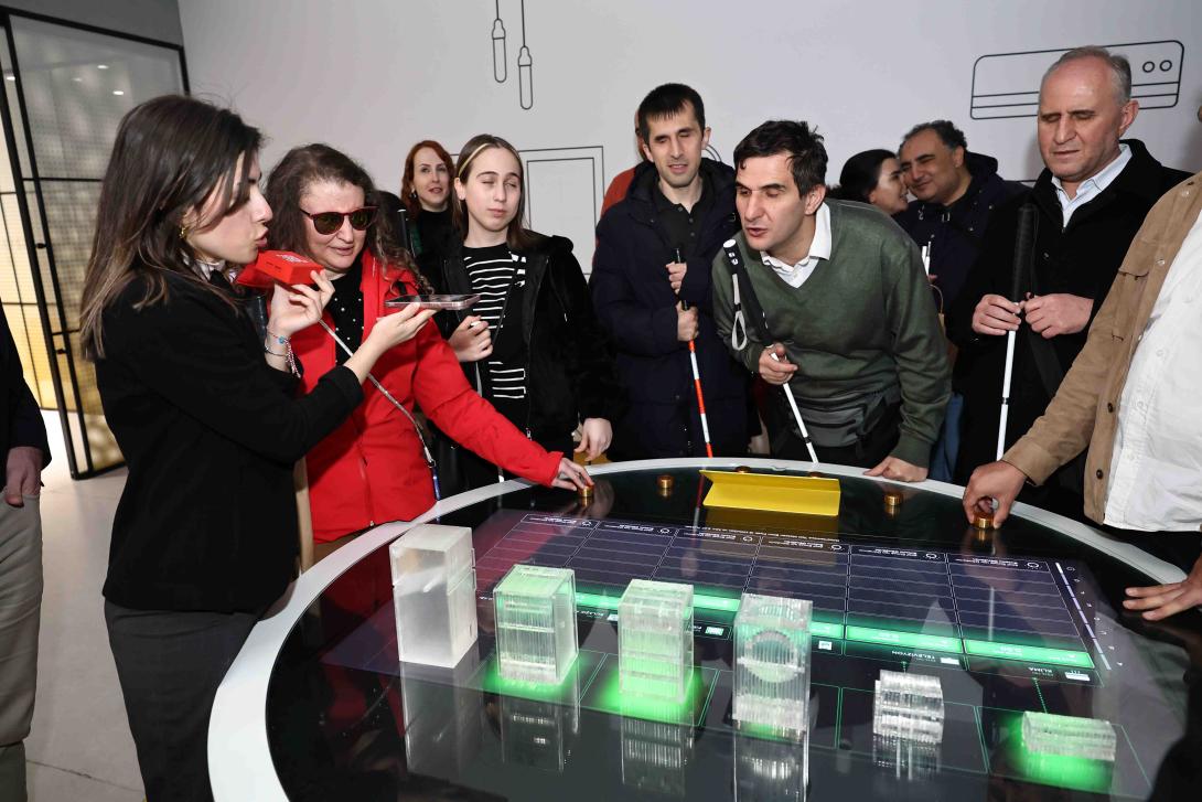 Blind visitors interacting with tactile objects of the exhibition